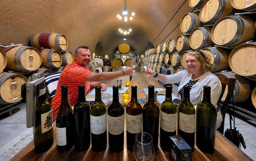 A couple toasting during a private cellar tasting at Aum Cellars in Napa Valley
